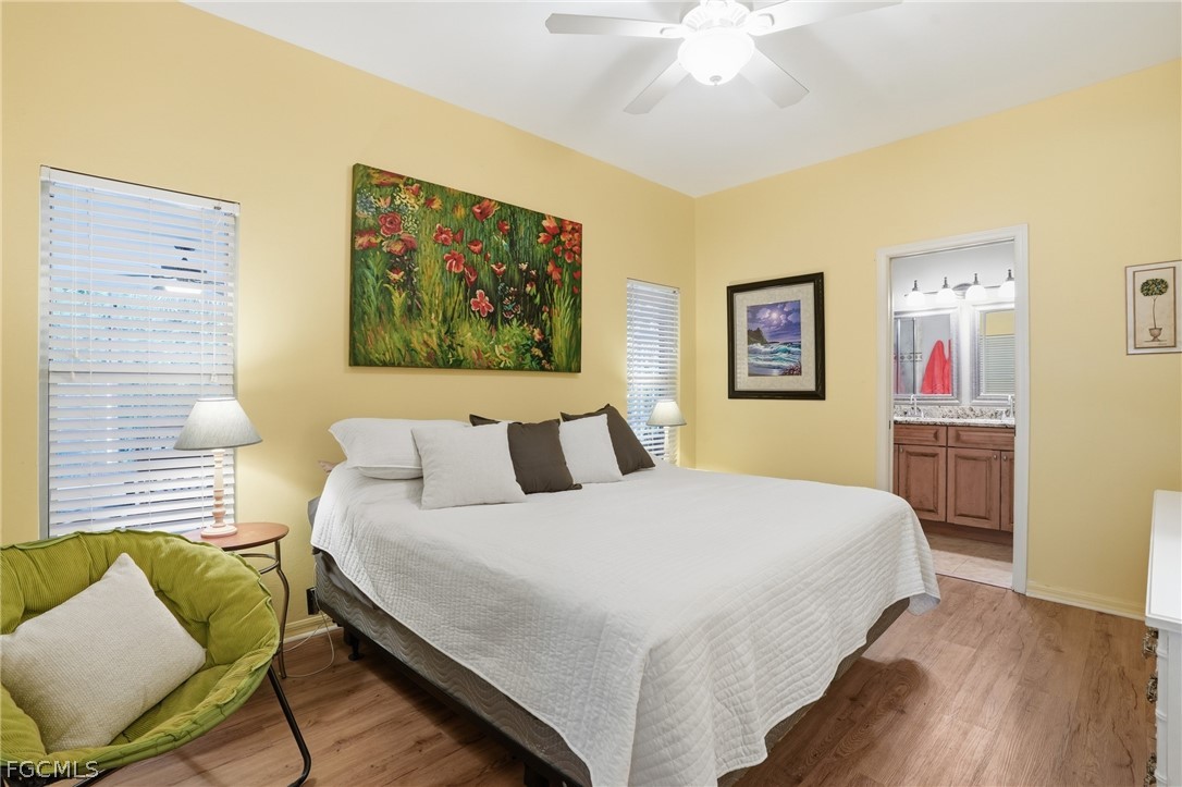 10730 Rio Mar Circle Estero, FL 33928 - Photo 15 of 47 a bedroom with a bed and a chandelier