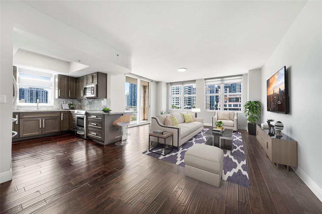 a living room with furniture flat screen tv and wooden floor