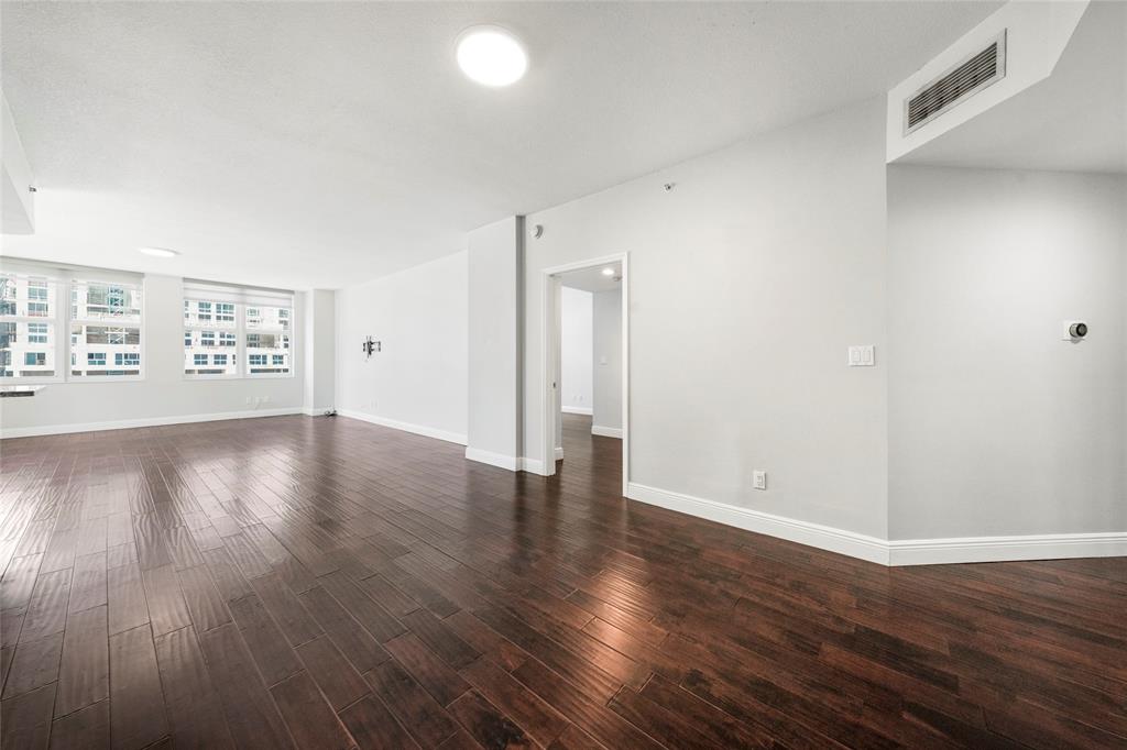 511 Southeast 5th Avenue, Unit 1116 Fort Lauderdale, FL 33301 - Photo 15 of 45 an empty room with wooden floor and windows