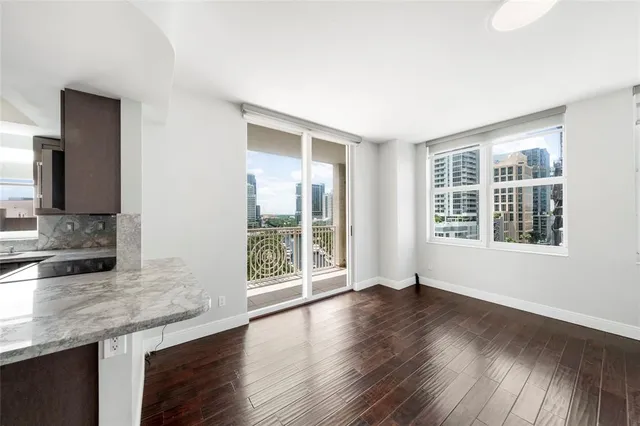 a kitchen with granite countertop wooden floors and wide window