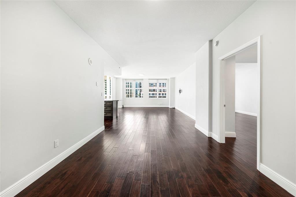 511 Southeast 5th Avenue, Unit 1116 Fort Lauderdale, FL 33301 - Photo 20 of 45 an empty room with wooden floor and windows