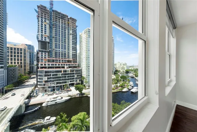 a view of a balcony with a floor to ceiling window and wooden floor