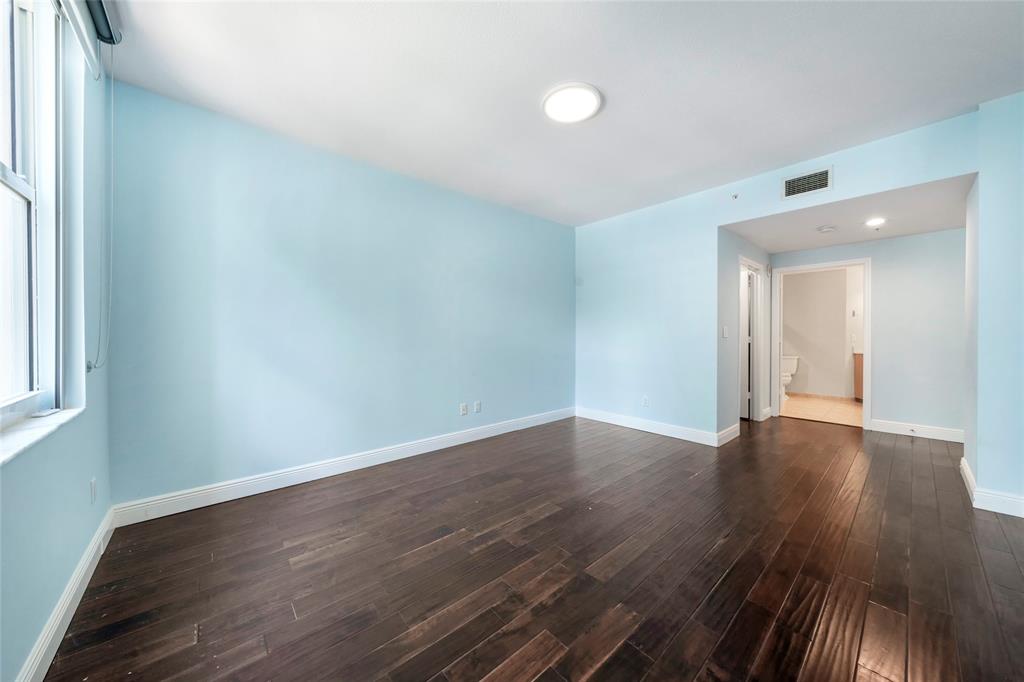 511 Southeast 5th Avenue, Unit 1116 Fort Lauderdale, FL 33301 - Photo 25 of 45 a view of an empty room with wooden floor and a window
