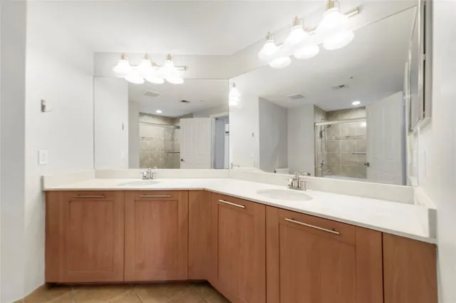 a bathroom with a sink double vanity and a mirror