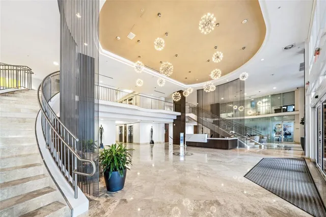 an entryway with wooden floor and windows