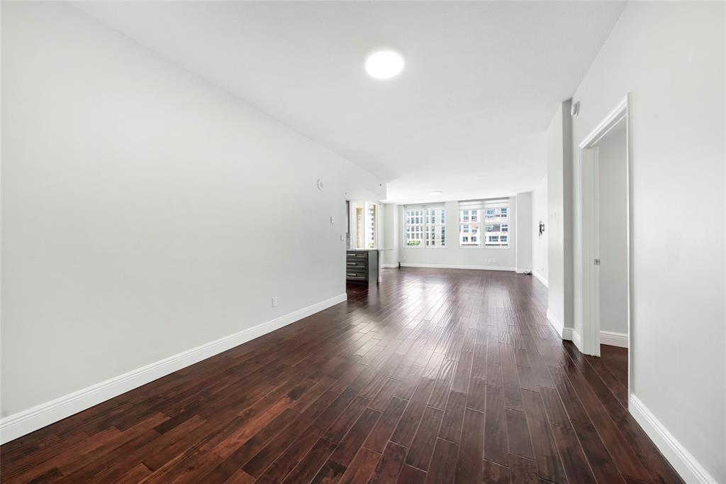 511 Southeast 5th Avenue, Unit 1116 Fort Lauderdale, FL 33301 - Photo 8 of 45 an empty room with wooden floor and windows