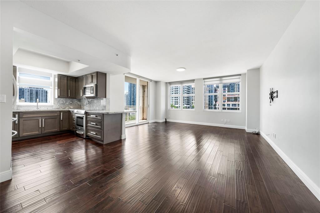 511 Southeast 5th Avenue, Unit 1116 Fort Lauderdale, FL 33301 - Photo 9 of 45 a view of a big room with wooden floor and a kitchen