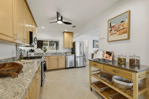 a kitchen that has a lot of cabinets in it and appliances