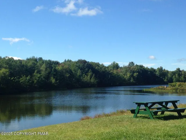 a view of a lake with houses in the back