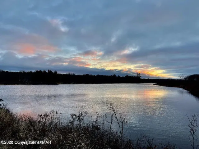 a view of lake with sunset