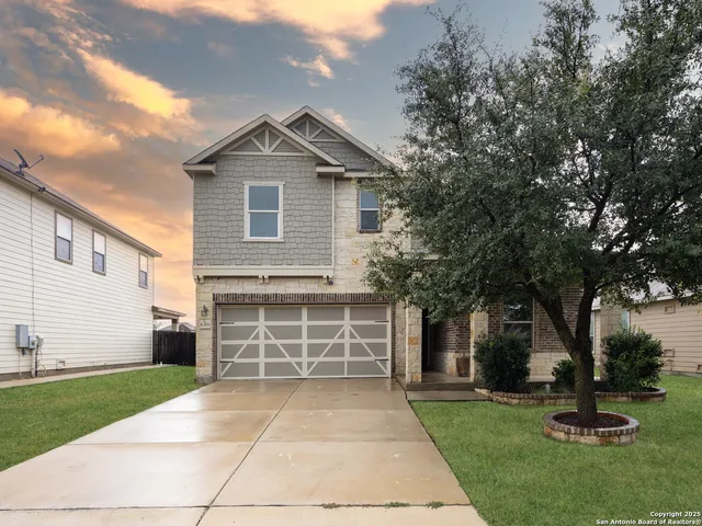 a front view of a house with a yard and garage