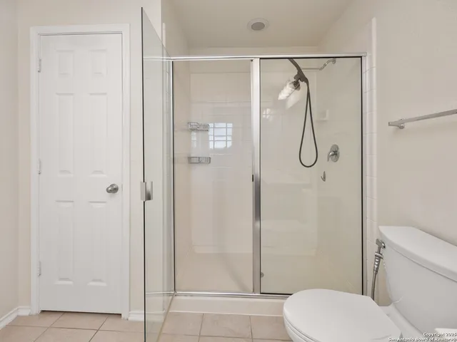 a bathroom with a shower and toilet
