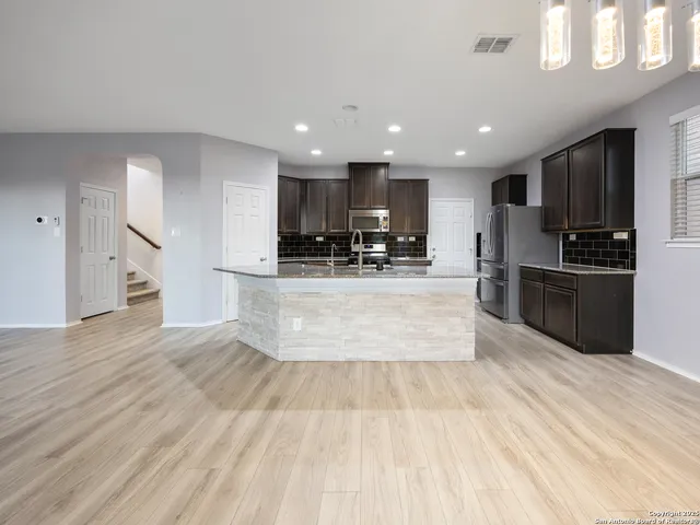 a large kitchen with stainless steel appliances lots of counter top space