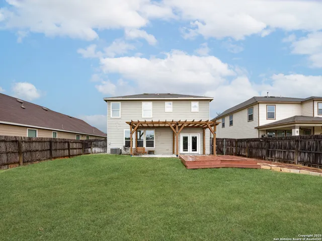 a view of a house with a big yard and sitting area