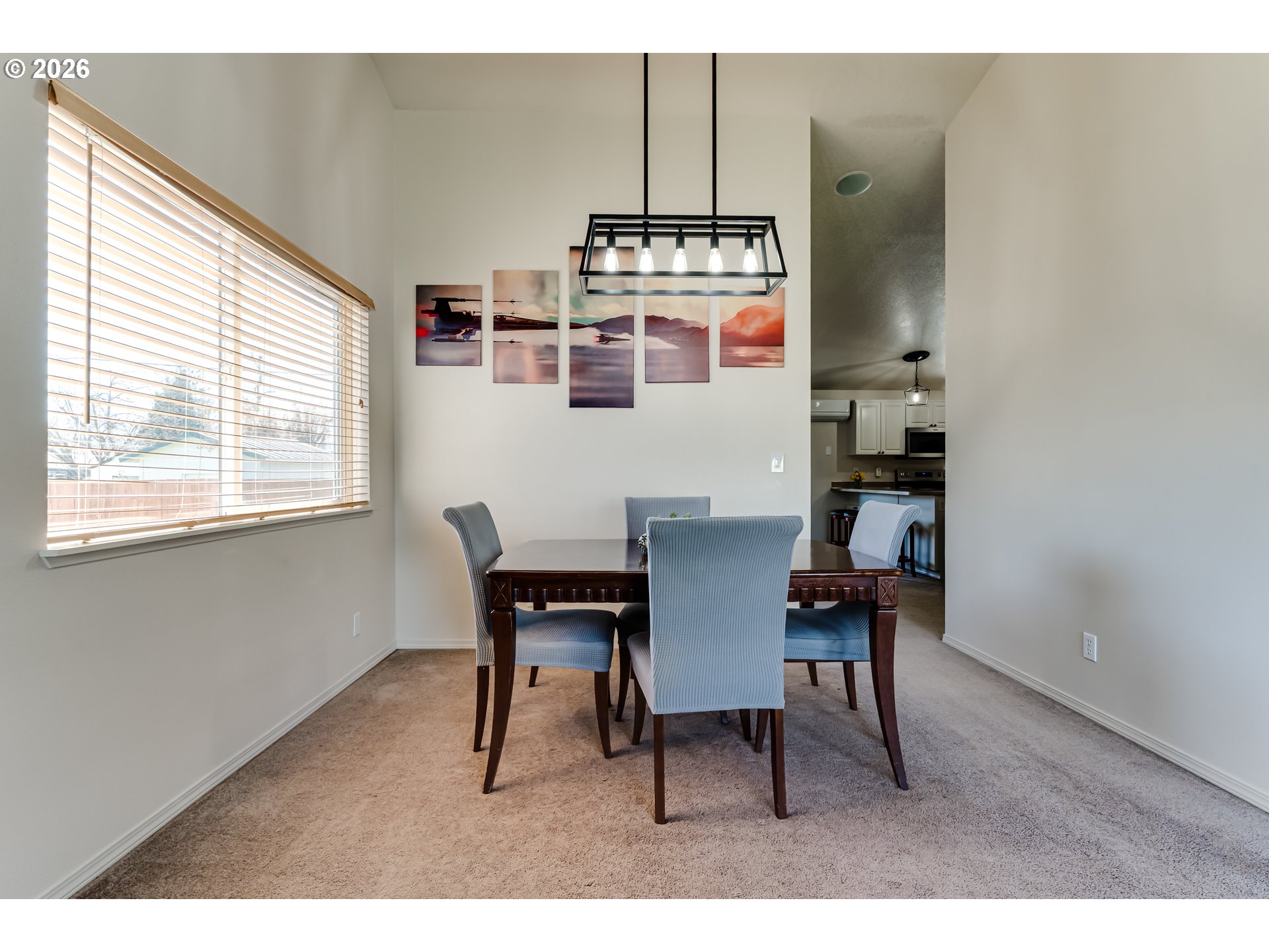 549 Gilfry Avenue Creswell, OR 97426 - Photo 11 of 44 a kitchen with stainless steel appliances kitchen island granite countertop a dining table chairs and a white refrigerator