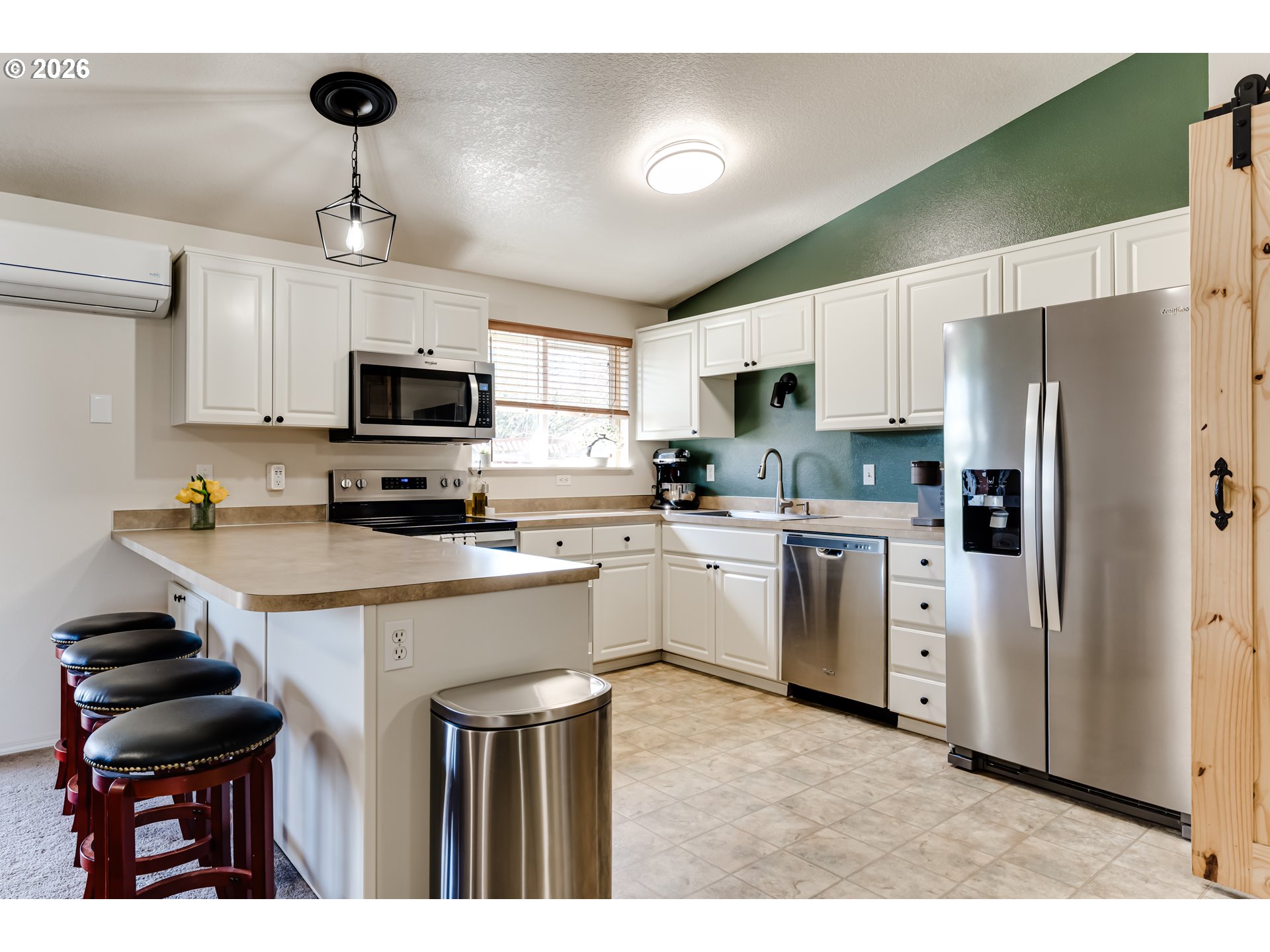 549 Gilfry Avenue Creswell, OR 97426 - Photo 14 of 44 a kitchen with a refrigerator a sink cabinets and wooden floor
