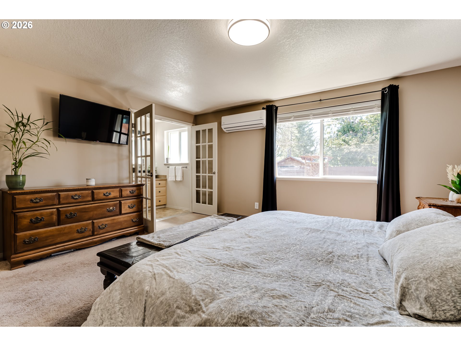 549 Gilfry Avenue Creswell, OR 97426 - Photo 25 of 44 a bedroom with a bed and flat screen tv