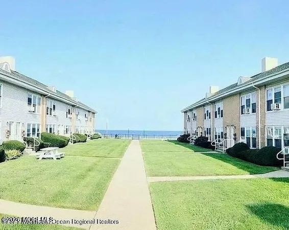 a view of a house with a big yard and large trees