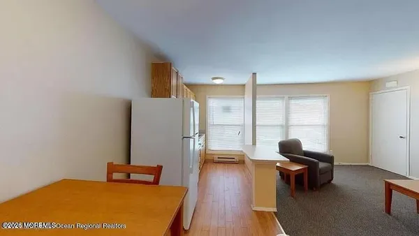 a bedroom with furniture and a large window