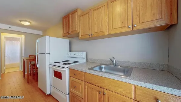 a kitchen with stainless steel appliances granite countertop a sink a refrigerator and a stove