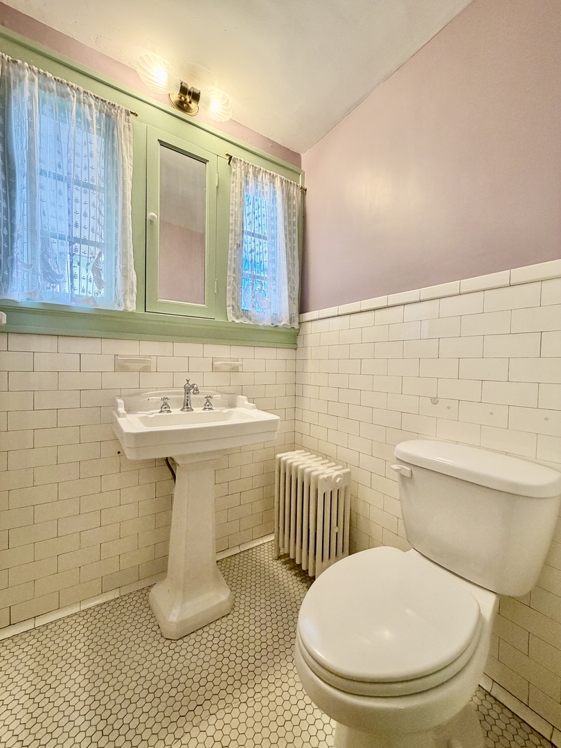 841 Douglas Avenue Elgin, IL 60120 - Photo 20 of 75 a bathroom with a toilet a sink and mirror
