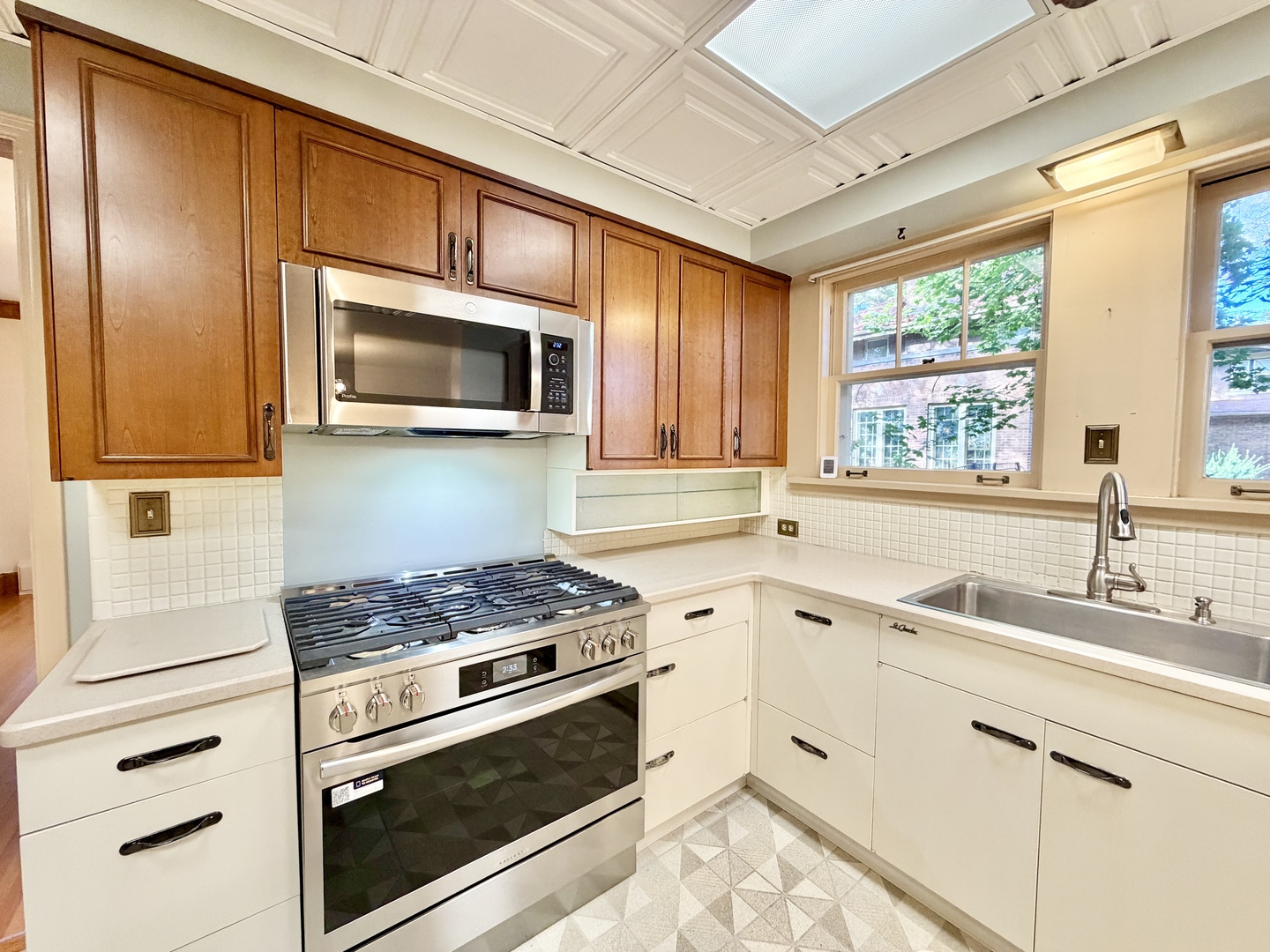 841 Douglas Avenue Elgin, IL 60120 - Photo 28 of 75 a kitchen with stainless steel appliances granite countertop a sink a stove and microwave