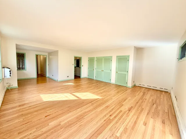 a view of a house with a big yard and large trees