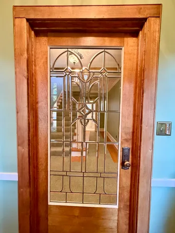 an empty room with wooden floor and fireplace