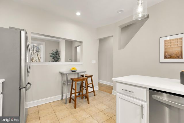 a view of kitchen with furniture and refrigerator