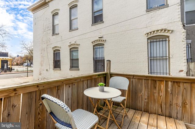 a balcony with table and chairs