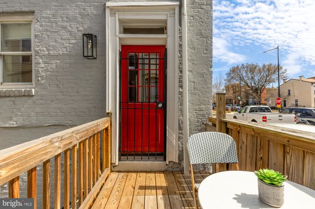 a front view of a house with outdoor seating