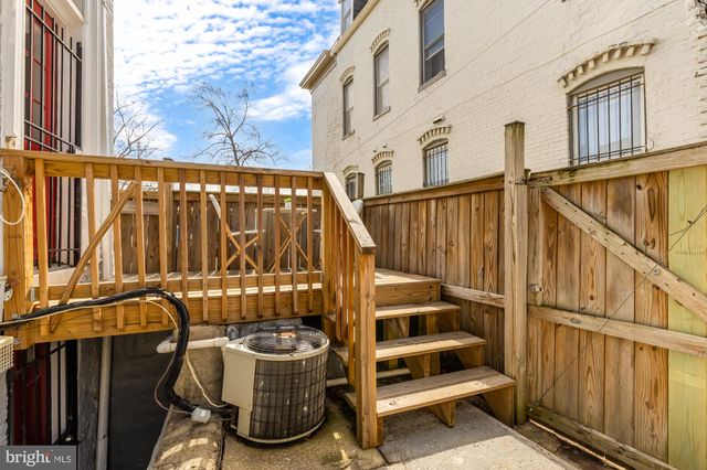 a view of an entryway with wooden floor and stairs