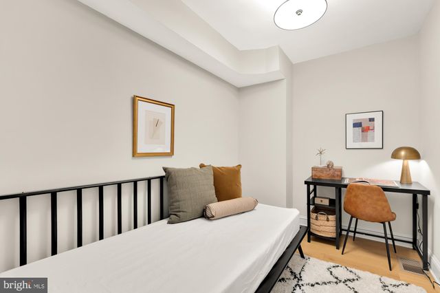 a bedroom with a bed and chair