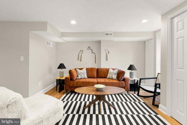 a living room with furniture and a rug