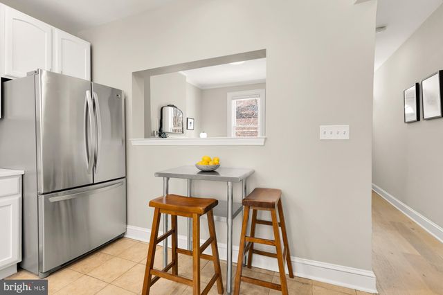 a kitchen with stainless steel appliances a refrigerator and a refrigerator
