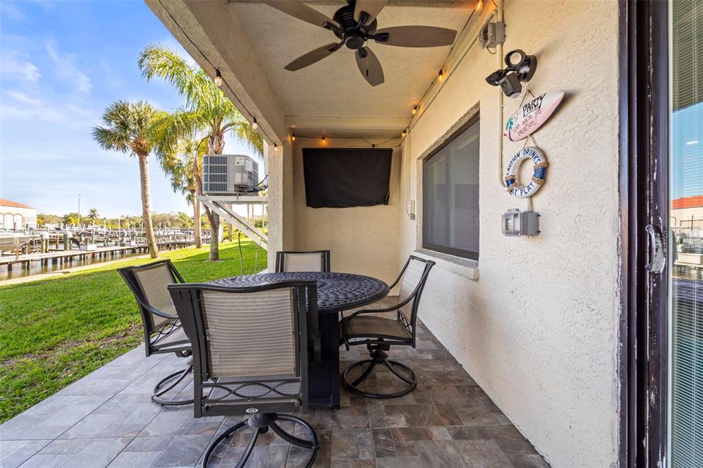 2385 Hanover Drive Dunedin, FL 34698 - Photo 23 of 87 a view of a patio with a table and chairs