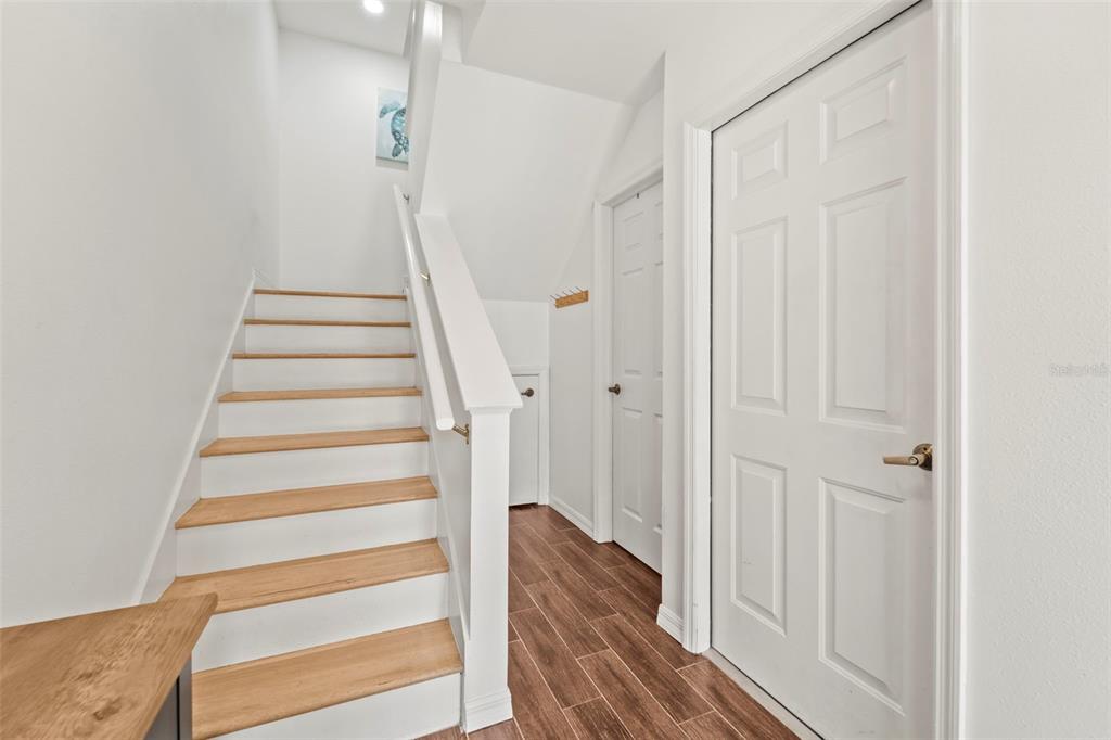 2385 Hanover Drive Dunedin, FL 34698 - Photo 46 of 87 a view of a hallway with wooden floor and entryway