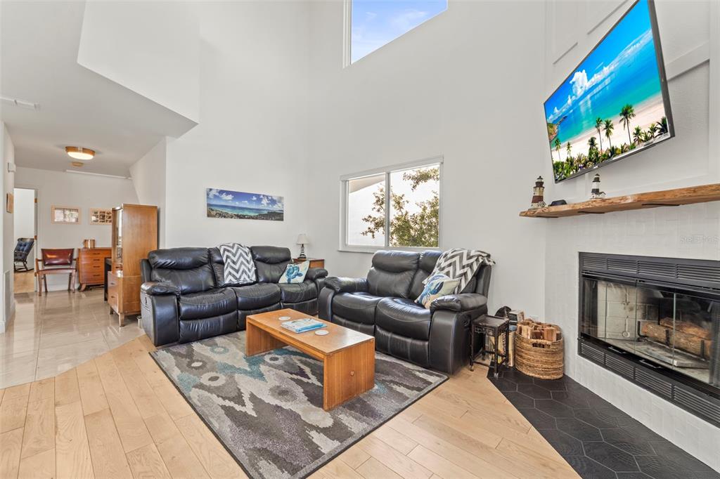 2385 Hanover Drive Dunedin, FL 34698 - Photo 5 of 87 a living room with furniture and a fireplace