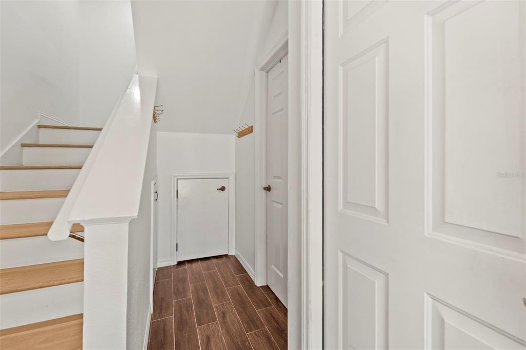 2385 Hanover Drive Dunedin, FL 34698 - Photo 56 of 87 a view of a hallway with wooden floor and entryway