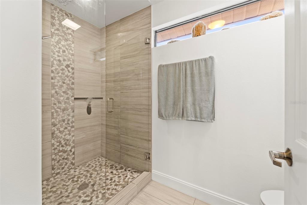 2385 Hanover Drive Dunedin, FL 34698 - Photo 68 of 87 a bathroom with a shower and a toilet