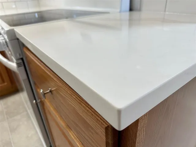 a kitchen with stainless steel appliances granite countertop a stove top oven a sink dishwasher and a refrigerator