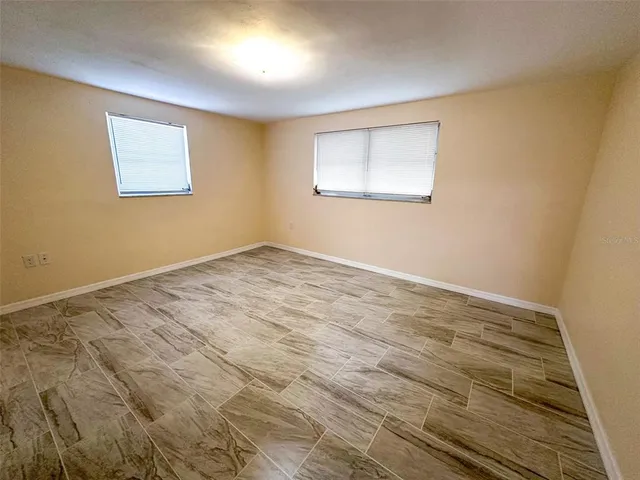 a bathroom with a granite countertop sink toilet a mirror and shower
