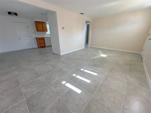 a kitchen with sink a microwave and cabinets