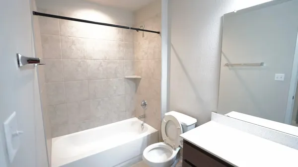 a bathroom with a bathtub a sink and a mirror