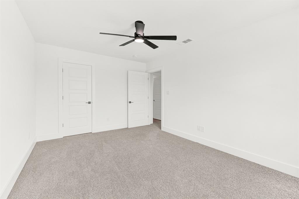 9471 Timberleaf Drive Dallas, TX 75243 - Photo 21 of 39 Spacious room featuring light gray carpeting, crisp white walls, contemporary ceiling fan with integrated lighting, and two paneled interior doors with matte black hardware