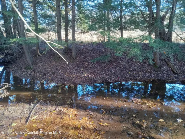 a view of swimming pool with a table and chairs under an umbrella