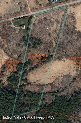 a view of a yard with wooden fence