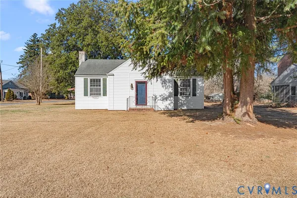 a front view of a house with a yard covered with snow