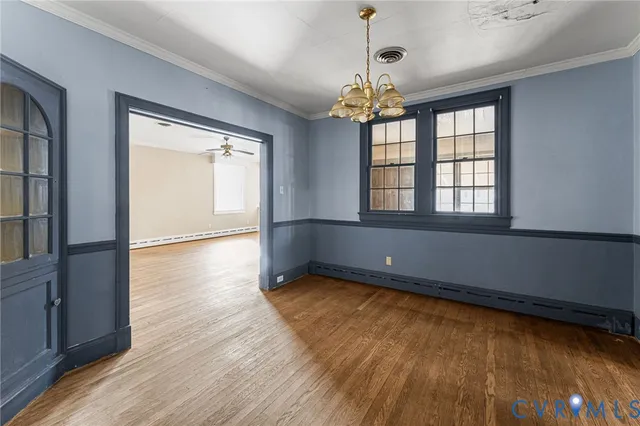 wooden floor in an empty room with a window