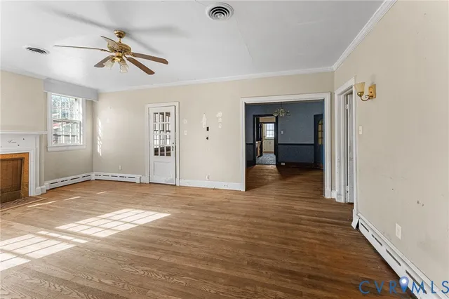 wooden floor in an empty room with a window
